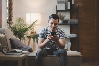 Hafta sonları evde rahatlamak, evdeki kanepede akıllı telefon kullanmak, arkadaşlarını aramak ve mutlu bir şekilde konuşmak, akıllı telefondan arkadaşlarınla video görüşmesi yapmak, internet aktiviteleri yapmak için akıllı telefonunu kullanmak..