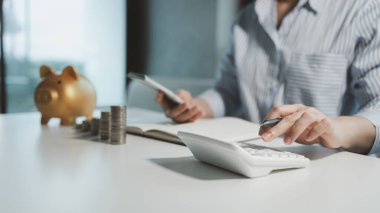 Bir işletme sahibi, bir finans kitabına para sayıyor ve notlar tutuyor, finansör, müşterinin yatırımından elde edilen geliri teyit ediyor, muhasebeci, toplam ne kadar para olduğunu hesaplıyor..