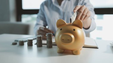 Muhasebeci domuz kumbarasına para yatırıyor, Financier tavsiye almaya gelen müşterilere tasarruf yöntemleri getiriyor, çalışanlar müşterilerin tasarruflarını alıyor ve onları güvende tutuyor..
