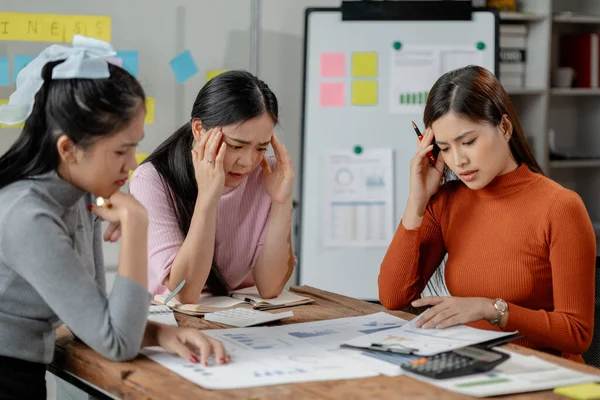 Frustrated upset multiracial business team people sad with bad work result in report disappointed in corporate bankruptcy failure crisis worried of paperwork problem sit at table at office meeting.