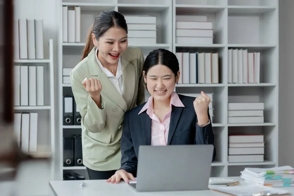 Joyful businesswoman freelancer entrepreneur smiling and rejoices in victory while sitting at desk after working finishing project, Excited happy woman, overjoyed motivated.