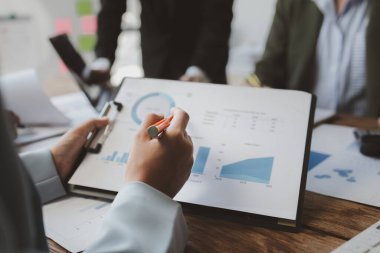 Finansal veri analizi üzerinde çalışan analist ekibi, iş stratejik planlamasının pazarlama göstergesi olarak, ödemeleri gereken vergileri hesaplıyorlar., 