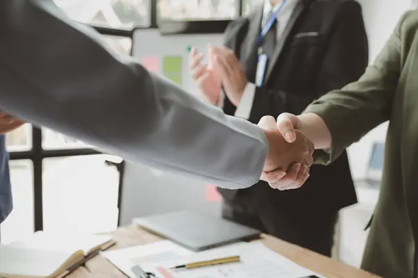 Make agreements with business partners, success in negotiating and entering into business contracts, handshake and meeting in teamwork, Shot of a businessman and businesswoman shaking hands,