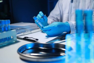 Bir araştırmacı not alıyor. Diğer araştırmacıların profili olarak laboratuvarda geliştiriliyor, bir biyolojik kimya bilimcisi bir patrona günlük çalışması hakkında bir rapor yazıyor..