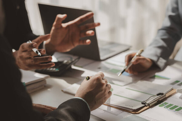 a group of businesspeople is discussing about new project that is coming up soon, those employees is shearing their idea to each other to choose the best strategy 