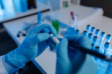 Bir bilim adamı deney için laboratuvar ekipmanı kullanır. Test tüpü kimyagerlerin deneylerde kullanması için gereklidir. Bilimsel araştırmacılar laboratuvar örneklerine yoğunlaşmalıdır.