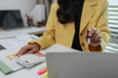 Özel ofisinde çalışan bir kadın yönetici ofisi, şirketinin ofisinde oturan bir kadın şirket sahibi, girişimci ve işkadını bir sürü evrak işiyle uğraşırlar.