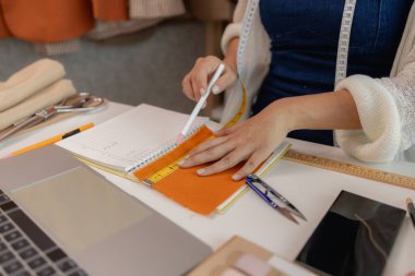 Atölyede dikiş malzemeleri kullanan kadın moda tasarımcısı, kumaş atölyesinde çalışan genç bir kadının portresi, atölyesinde çalışan genç bir terzi manzarası.