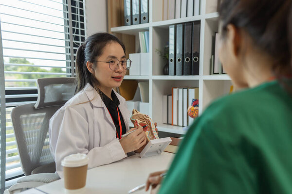 a female doctor is explaining the systems in the human body to two interns, three doctors are meeting to discuss the most appropriate treatment approach for the patient
