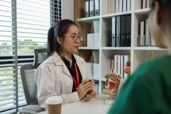 a female doctor is explaining the systems in the human body to two interns, three doctors are meeting to discuss the most appropriate treatment approach for the patient
