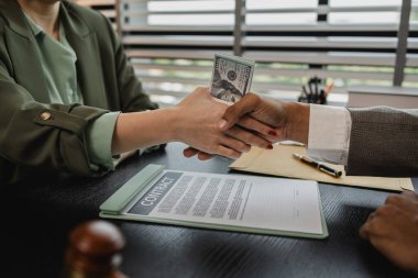 lawyer and client shake hands after receiving bribes for illegal deals, a client is bribing the opposing lawyer in order to win a case, corruption and bribery are illegal clipart