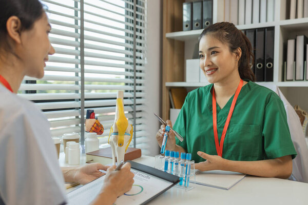 consultation between two doctors in the office, two medical students are discussing treatment guidelines for a patient assigned to them by a senior physician, nurse, brainstorming, hospital