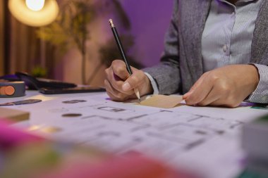 Güzel bir kadın mimar özel ofisinde çalışıyor çünkü kanunlara, mühendislere, ustabaşına ve müteahhitlere uygun olması için planların geliştirilmesine konsantre olması gerekiyor.
