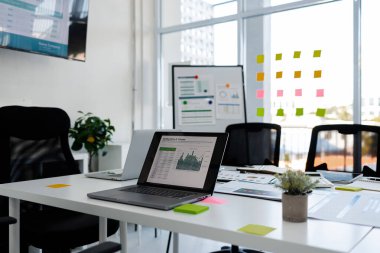 Şirketteki bir ofisin atmosferi, ofis malzemeleriyle dolu bir masa, güneş ışığı alan temiz camlı bir konferans odası, modern bir konferans odası atmosferi.