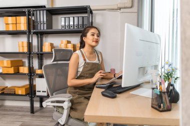 Depo müdürü verileri bilgisayara giriyor, bir çalışan depoda doğruluk için nakliye adreslerini kontrol ediyor, küçük bir işletme sahibi çevrimiçi bir iş deposunda çalışıyor.