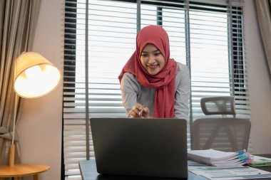 Müslüman bir kadın girişimci, şirketinin mali belgelerini, pazarlamasını, muhasebecisini, tesettüre katılmış, Müslüman bir şirket çalışanı, büyük bir finans kuruluşunda çalışıyor.