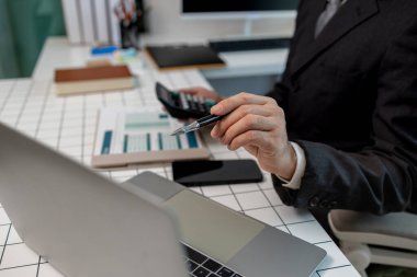 Muhasebeci, özel ofisindeki belgelerden mali tabloları hesaplar. Maliye memuru, şirket gider belgelerini kontrol eder. İşadamı da belgelerle çalışır.