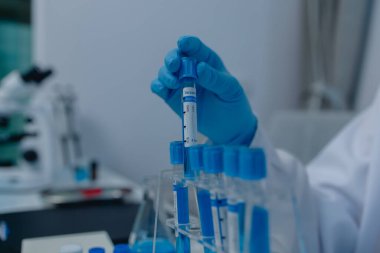 Bir kadın kimyager laboratuvarda çeşitli sıvı bileşiklerini test ediyor, bir bilim adamı laboratuvarda, laboratuarda, laboratuarda, deney tüpünde, bilimsel araştırmalar yapıyor.