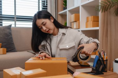 Tüm müşterilere göndermek için paket hazırlıyor. Bu girişimcinin küçük bir işletmesi var. Sme, internetten ürün satıyor.