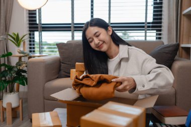 Tüm müşterilere göndermek için paket hazırlıyor. Bu girişimcinin küçük bir işletmesi var. Sme, internetten ürün satıyor.