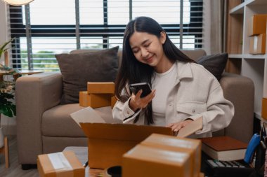 Tüm müşterilere göndermek için paket hazırlıyor. Bu girişimcinin küçük bir işletmesi var. Sme, internetten ürün satıyor.