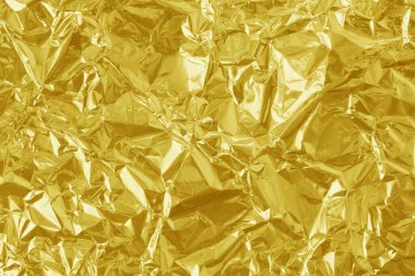 Parlak altın folyo desenli arka plan, buruşuk ve dalgalı sarı ambalaj kağıdı deseni.