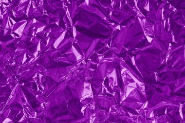 Shiny purple foil texture background, pattern of violet wrapping paper with crumpled and wavy.