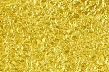 Parlak altın folyo desenli arka plan, buruşuk ve dalgalı sarı ambalaj kağıdı deseni.