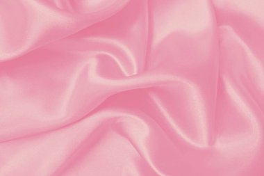 Yumuşak pembe kumaş dokusu arkaplanı, ipeğin veya keten deseninin ayrıntıları.