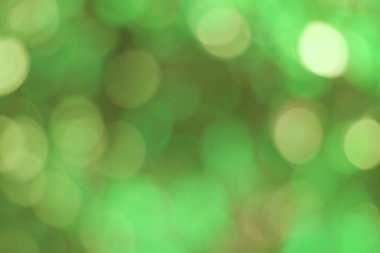 Yeşil bokeh soyut, doğal arkaplanda bulanık parlak ışık deseni.