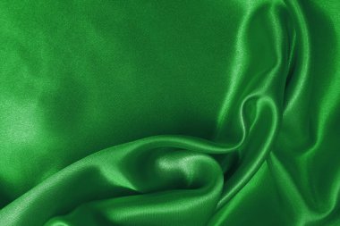 Yeşil kumaş dokusu arkaplanı, ipeğin veya keten deseninin ayrıntıları.