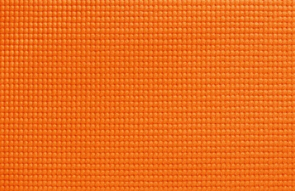 Orange yoga mat texture, pattern of rubber for background.