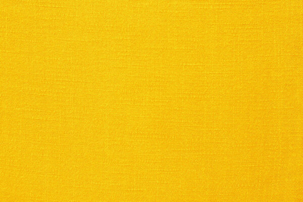 Желтое льняное полотно ткань текстуры для фона, натуральный текстильный узор.