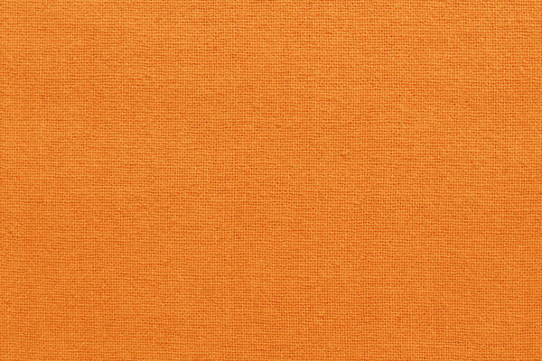 Текстура ткани из оранжевого хлопка для фона, натуральный текстильный узор.