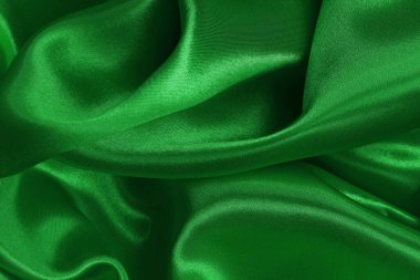 Green emerald fabric texture background, detail of silk or linen pattern.