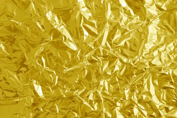 Parlak altın folyo desenli arka plan, buruşuk ve dalgalı sarı ambalaj kağıdı deseni.