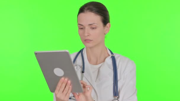 Young Female Doctor Using Digital Tablet Green Background — Stockvideo