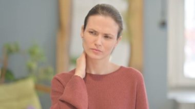 Young Woman in Pain Massaging Her Neck 