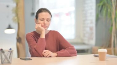 Tired Young Woman Sleeping while at Work