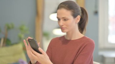 Young Woman using Smartphone for Browsing Internet