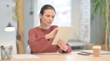 Young Woman using Digital Tablet, Browsing Internet