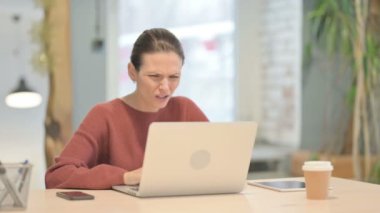 Young Woman Reacting to Loss While Working in Office
