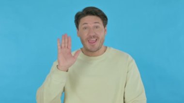 Handsome Young Man Talking on Online Video Call on Blue Background