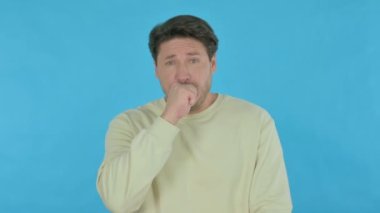 Sick Handsome Young Man Coughing on Blue Background