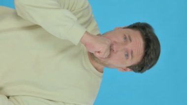 Sick Handsome Young Man Coughing on Blue Background, Vertical Video