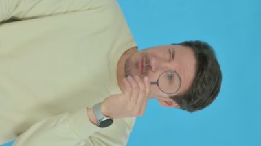 Handsome Young Man Searching Opportunity on Blue Background, Vertical Video