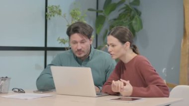 Creative Business People Discussing Online Work on Laptop