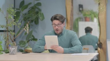 Shocked Middle Aged Businessman Reacting to Loss on Digital Tablet