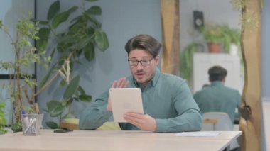Online Video Chat on Tablet by Middle Aged Businessman