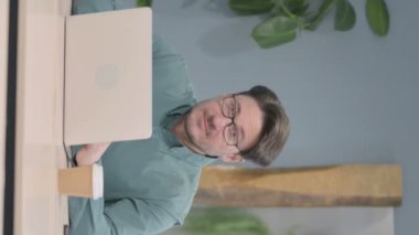 Vertical Video of Thumbs Up by Mature Adult Businessman Working on Laptop